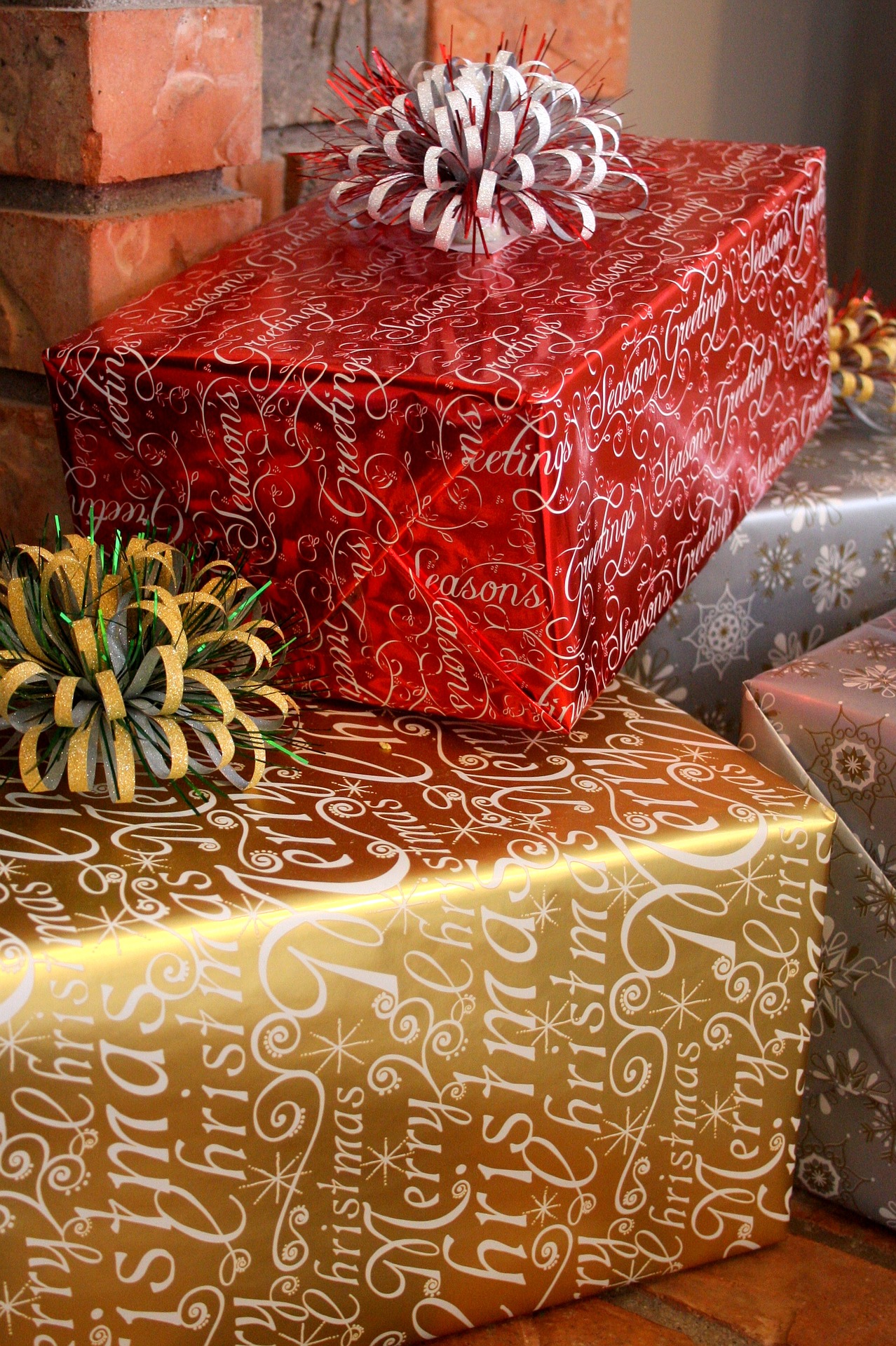 A Pile of Christmas Gifts in gold, red and silver wrapping paper
