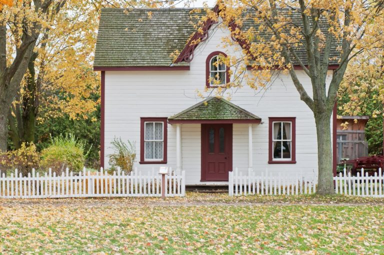 A white house, with white picket fence