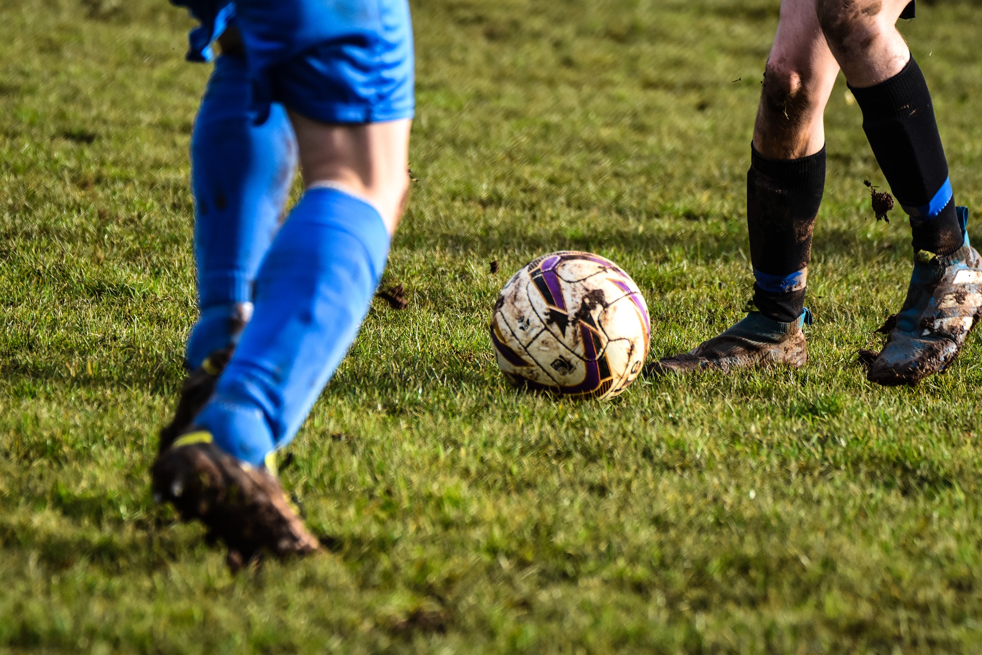 two football players passing a football