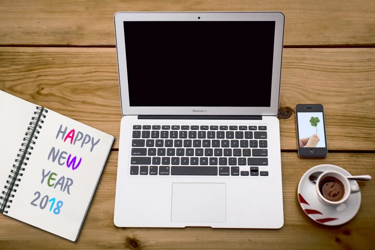 laptop, a coffee, phone and a 2018 diary