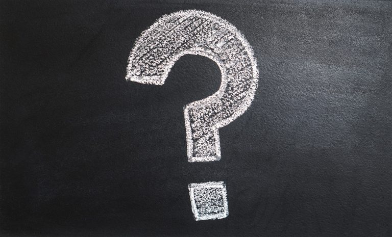 a question mark drawn in chalk on a blackboard