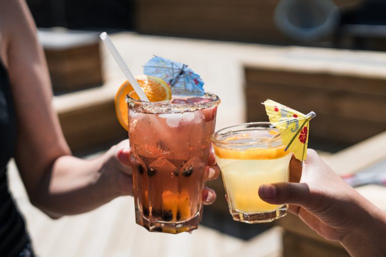 two women drinking alcoholic cocktail drinks