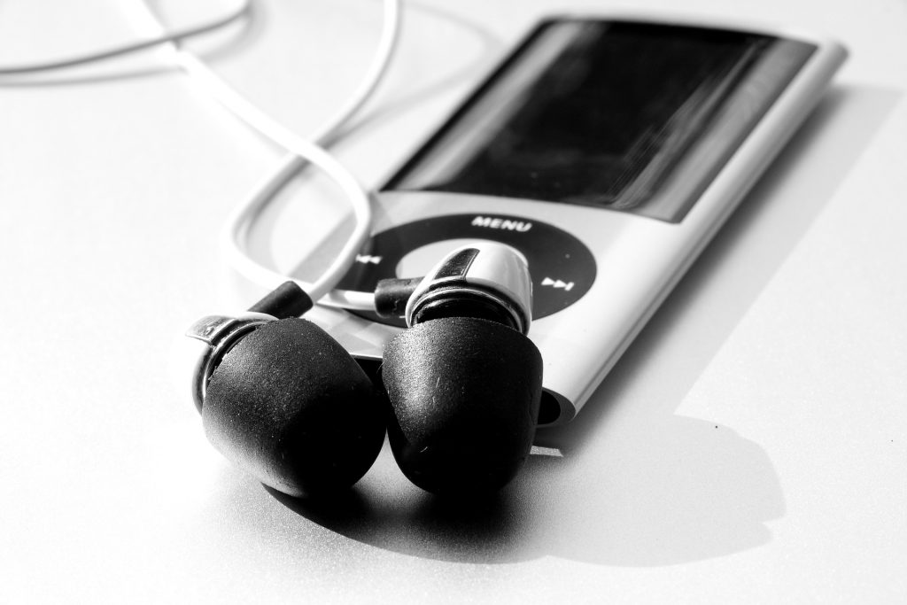 A silver iPod and earphones