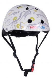 A white children’s helmet with black straps, decorated with dinosaur skeleton illustrations and green spiral designs—perfect for back to school 2018. The brand name "kiddimoto" is printed on the side in colourful letters.