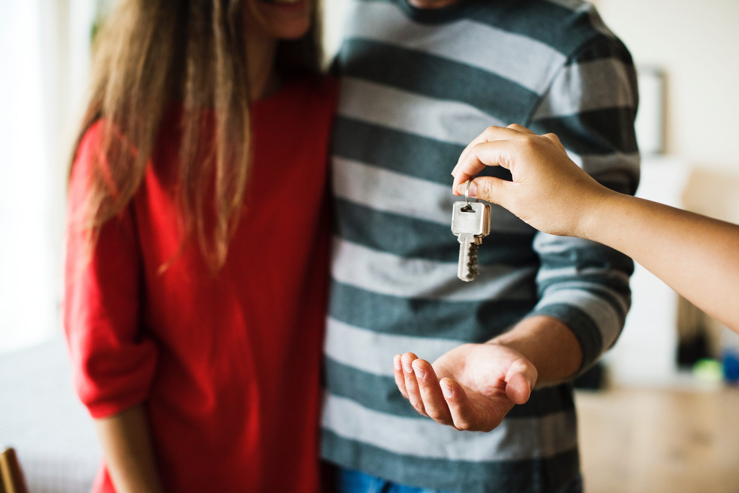 A couple being given their new home keys