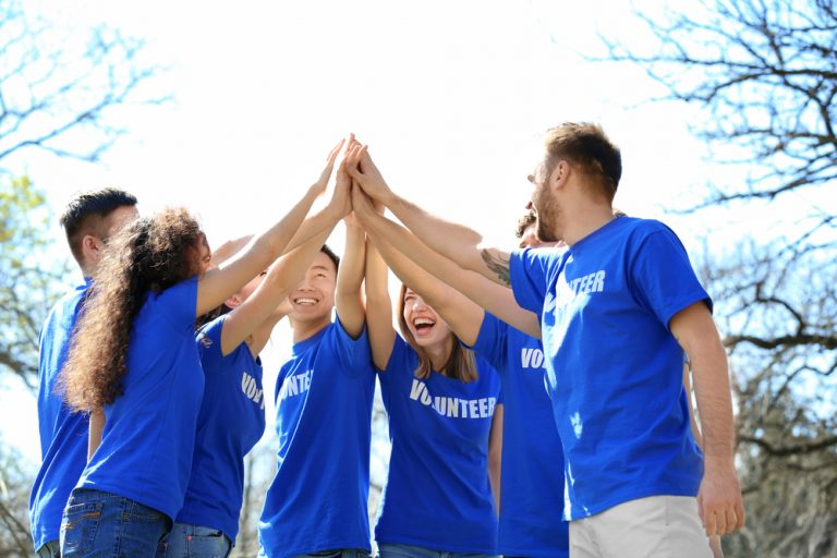 a group of volunteers high fiving