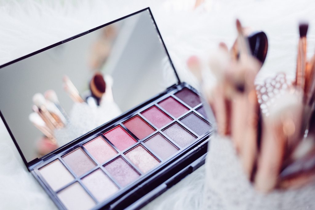 an eye shadow compact and make up brushes