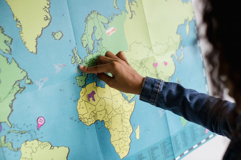 a man pinpointing the uk on a map