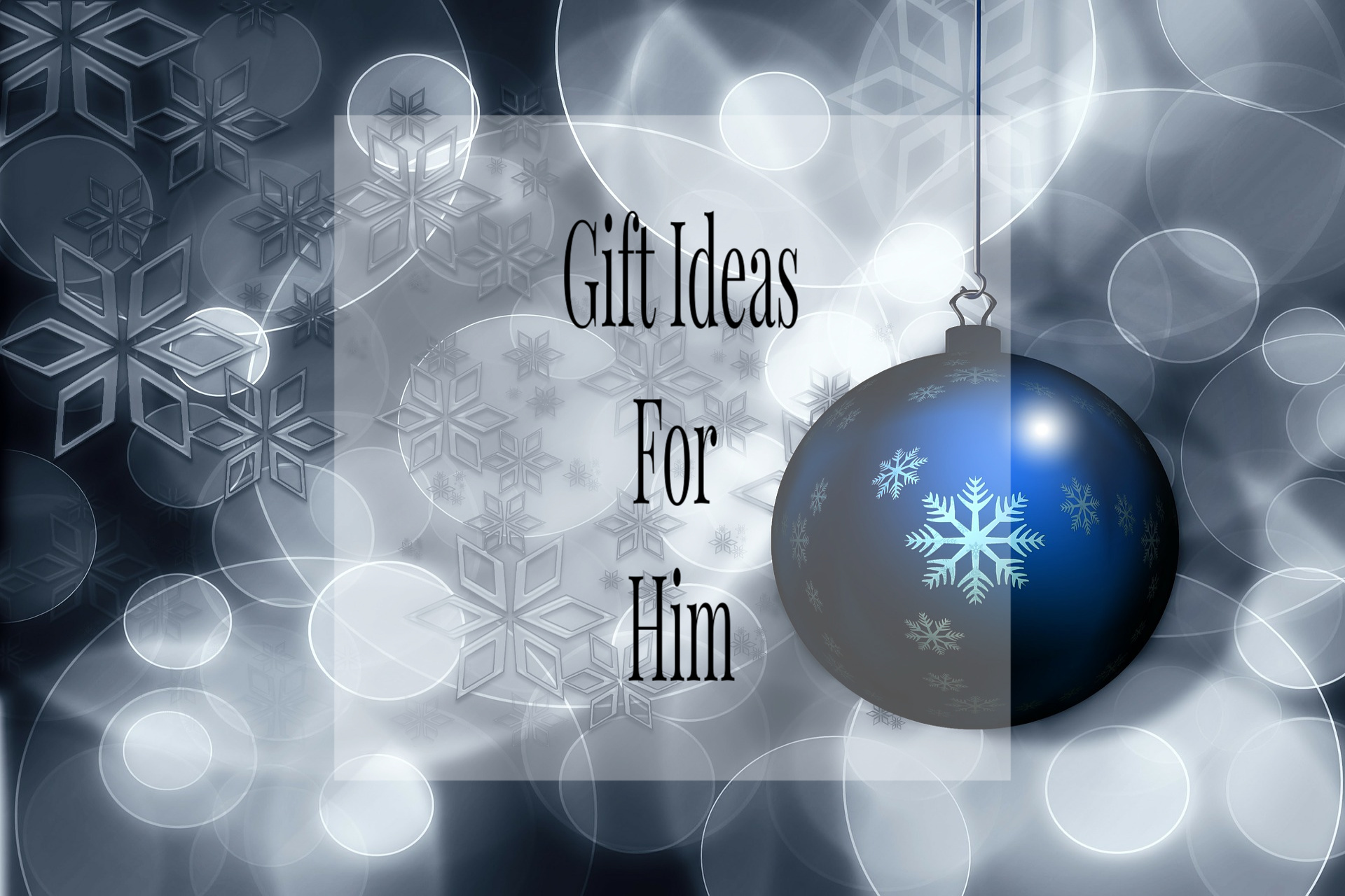 A blue bauble with a snowflake design hangs against a blurred, wintry background with snowflakes and bokeh lights. Overlaid text reads: "Gift Ideas For Him"—the perfect inspiration for your Christmas gift ideas for him.