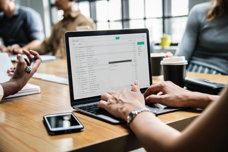 woman sending an email at a desk
