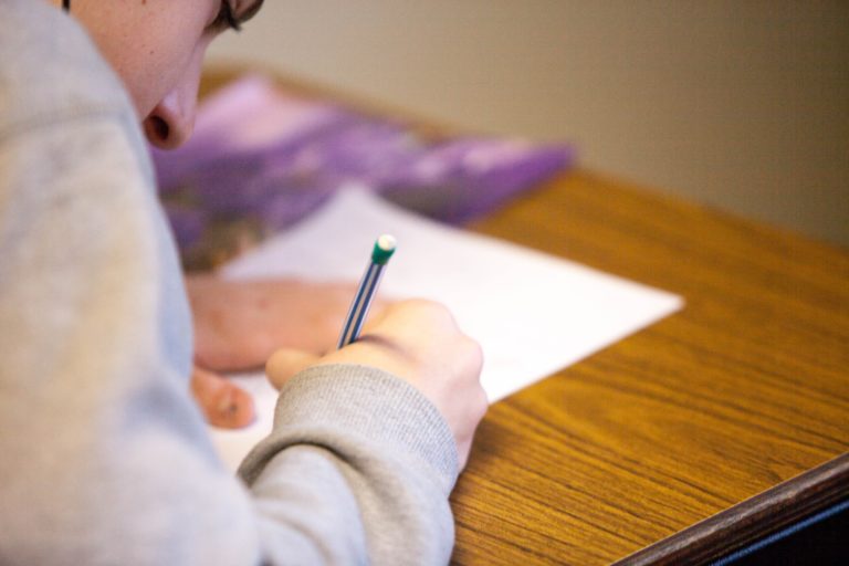 A student working at a desk completing school work