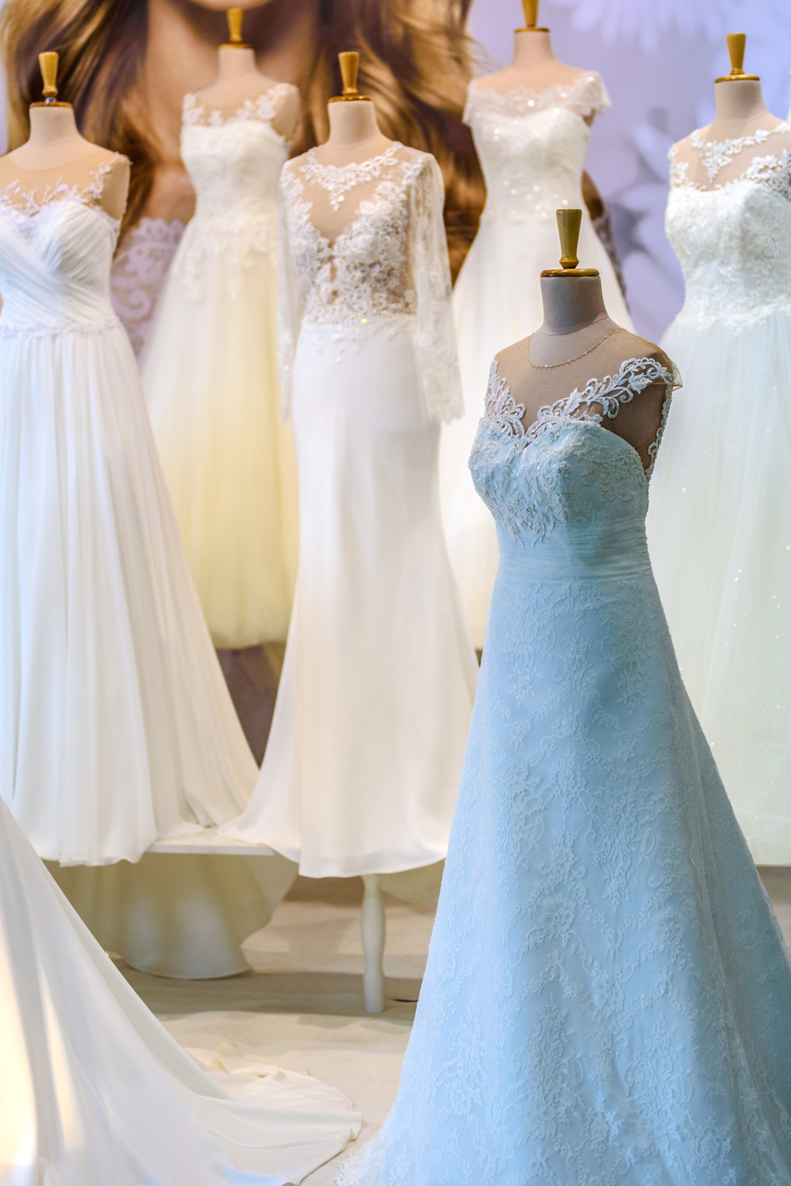 a number of wedding dresses on mannequins