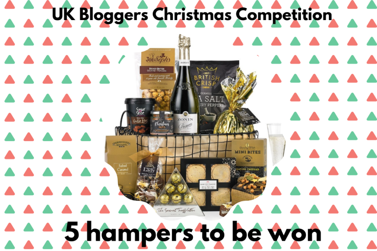 A festive hamper filled with snacks, biscuits, crisps, cheese, a bottle of wine, and a glass, features text reading “UK Bloggers Christmas Competition” and “5 hampers to be won” on a red and green patterned background.