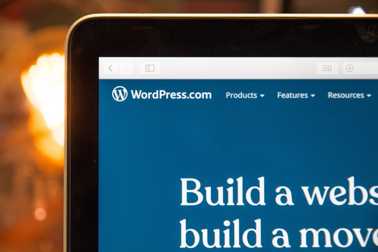 A computer screen displaying the WordPress.com website homepage, with the WordPress logo and navigation menu visible at the top, and part of the phrase “Build a website” shown—a reminder of things you should consider when setting up a blog.