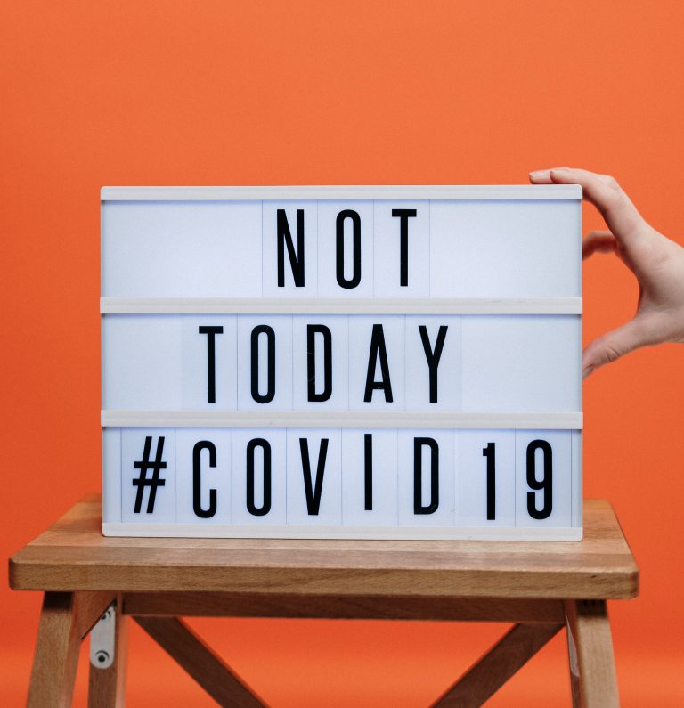 lightbox with the words "not today #COVID19" sat against an orange wall