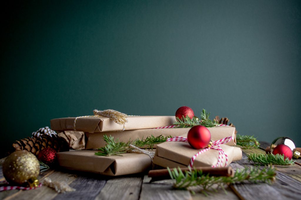 Christmas presents wrapped in brown paper and tied with red and white striped ribbon