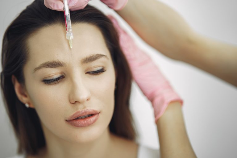 woman having a botox injection in her forehead
