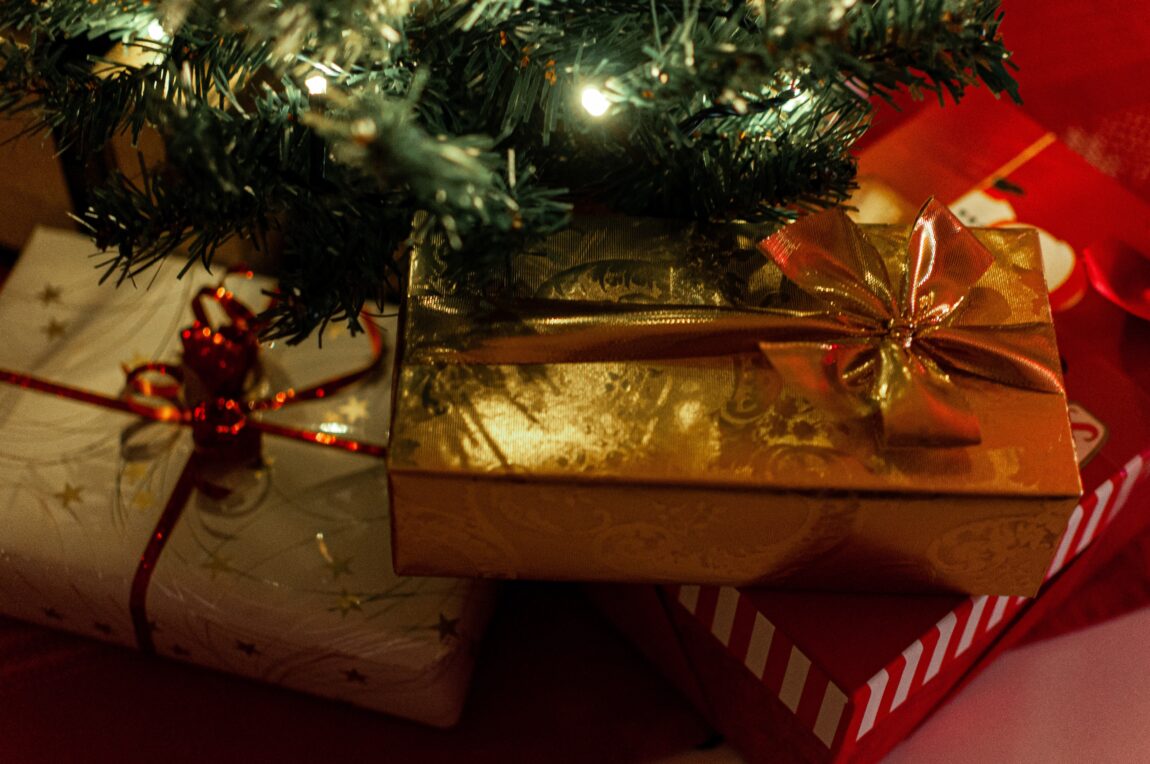 Brightly wrapped presents under a Christmas tree