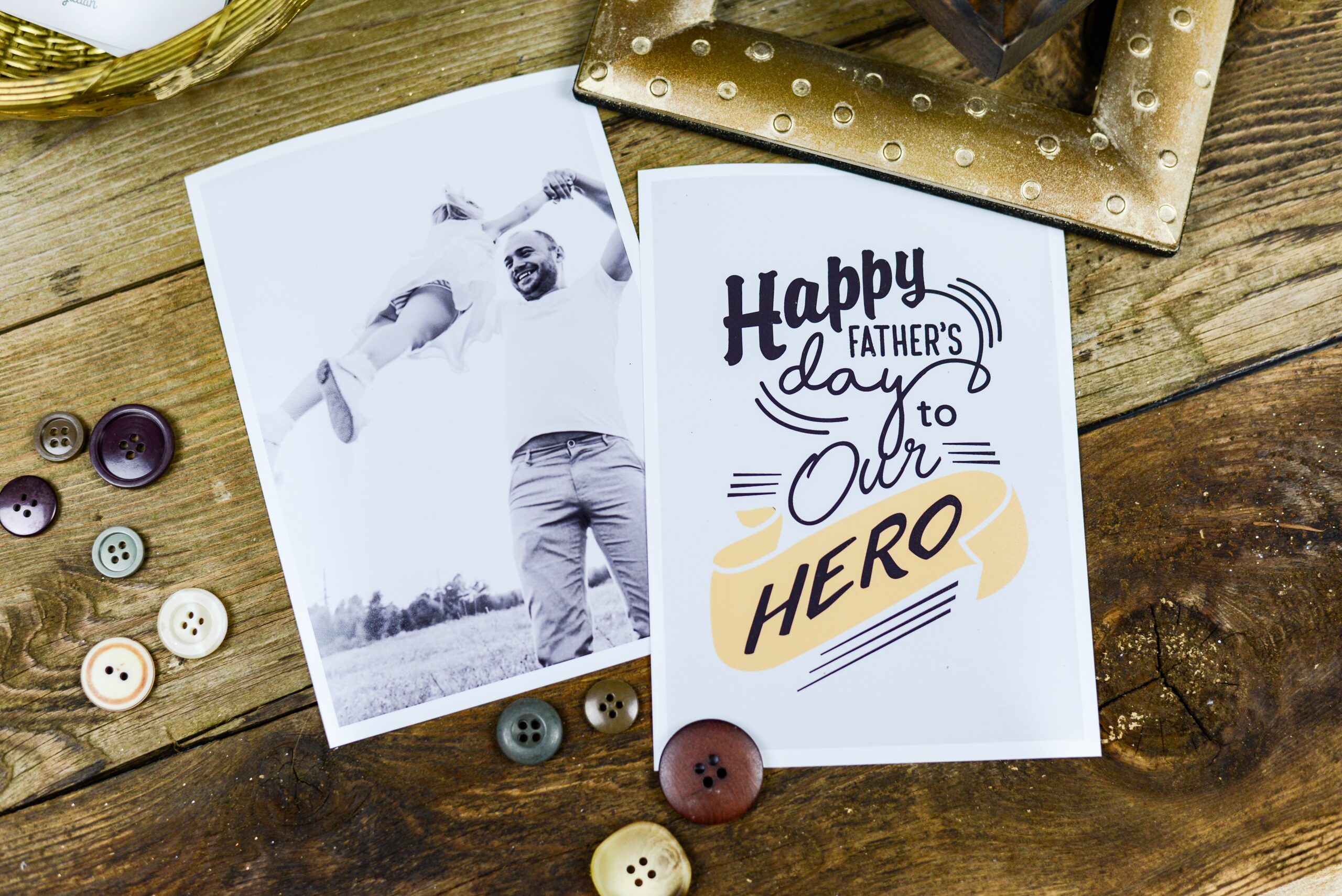 two cards on brown wooden surface on is a Father's Day card