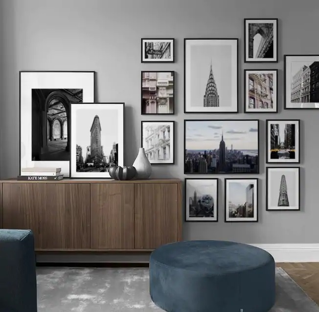 a number of New York pictures in frames on a wall