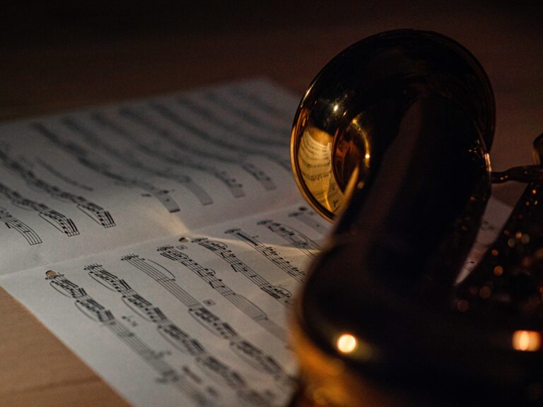A saxophone sat on top of a sheet of music