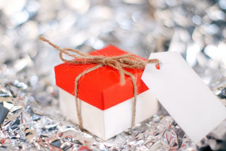 A red and white gift box sat on a silver background