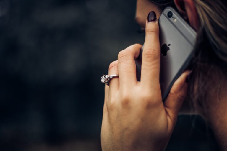 A woman holding an iPhone up to her ear