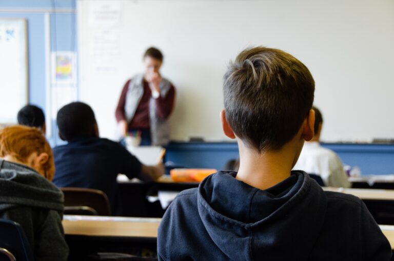 A group of people in a classroom discussing How to Boost Your Child's Education: Tips for Parents.
