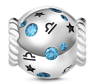 A silver, spherical Gnoce bead charm with twisted rope-like edges, decorated with black star symbols, musical note cut-outs, and embedded blue gemstones.