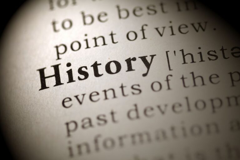 A close-up of a dictionary page highlights the word "History" in bold, with surrounding text slightly blurred and out of focus, emphasising the importance of history in language.
